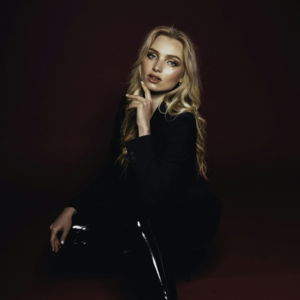 a woman sitting on the floor wearing black boots